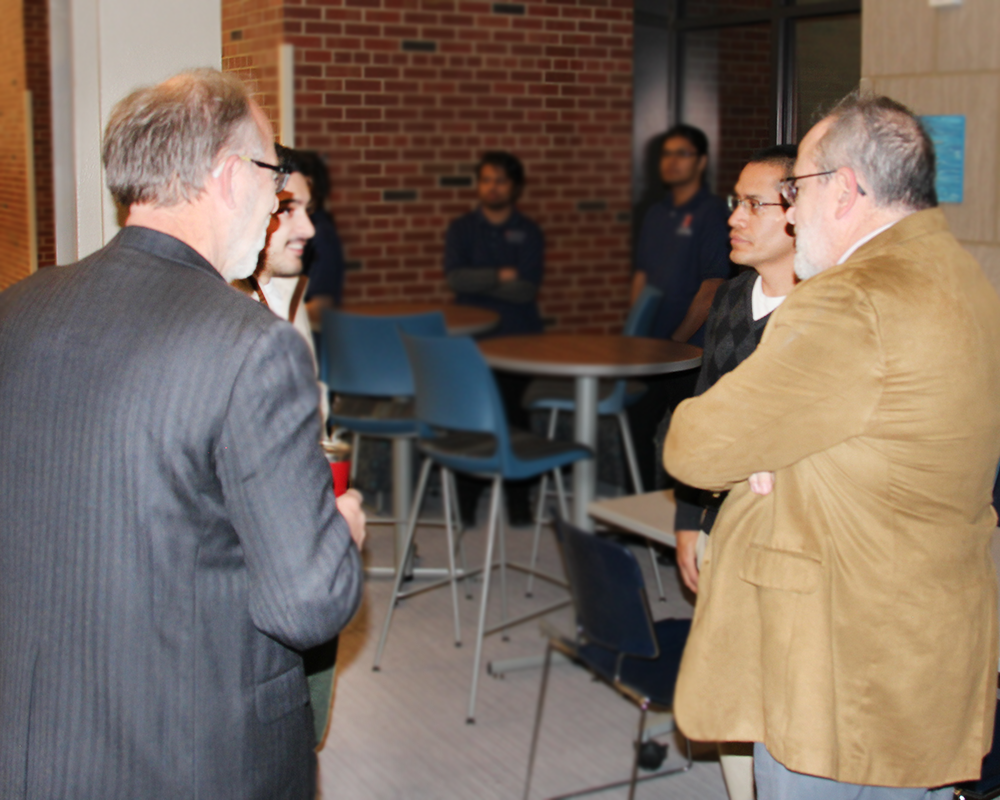 Godse talking with CEE faculty Rafeal Tinoco, Art Schmidt and Marcelo Garcia at the Winter 2024 CEE Graduation Reception