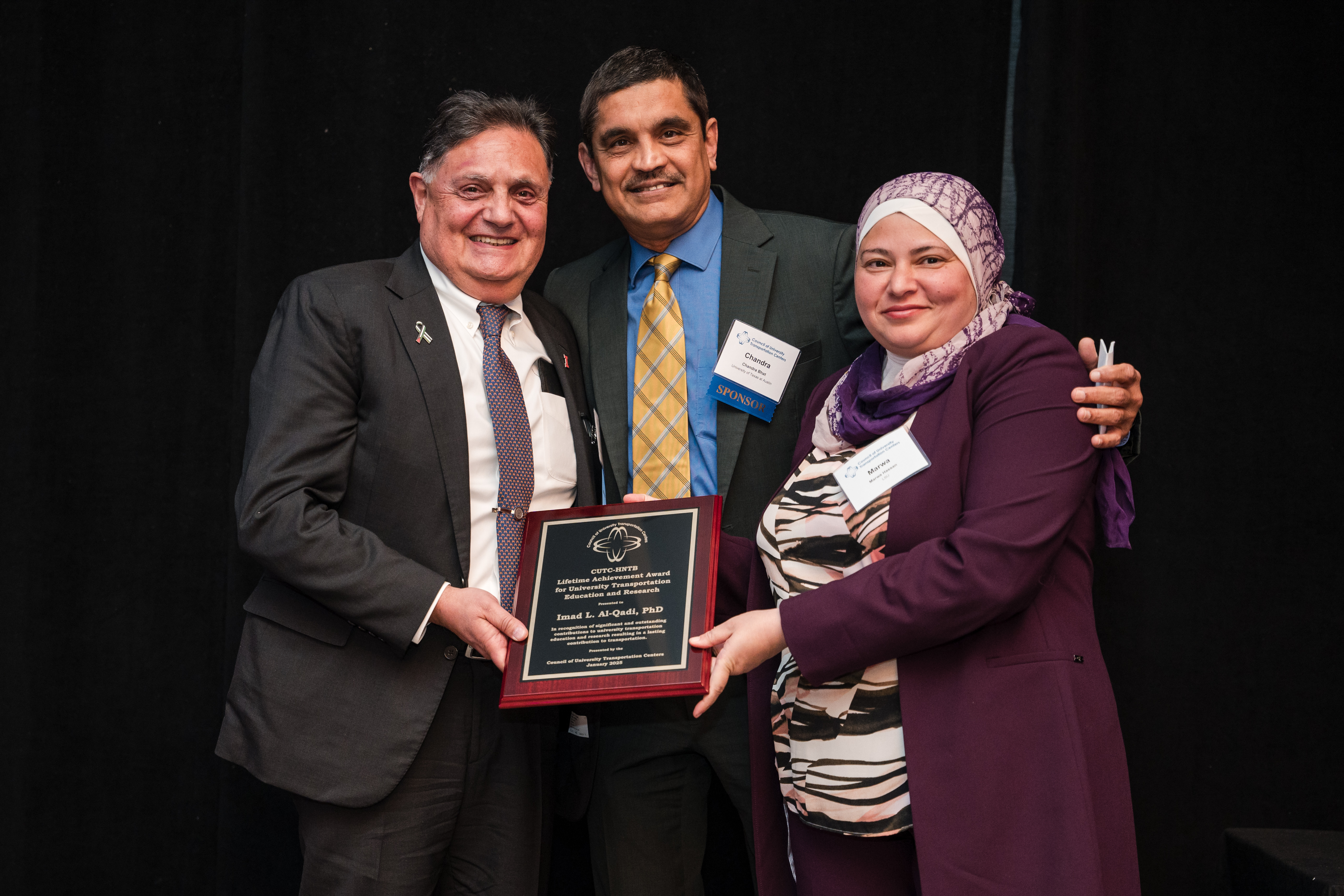 Photo credit: <em>Council of University Transportation Centers (CUTC)</em><br><br>From left: Al-Qadi smiling with Chandra Bhat, Joe J. King Chair in Engineering at the University of Texas at Austin, and CUTC&nbsp;Presidents Marwa Hassan at the award ceremony in Washington, D.C. on Jan. 4.