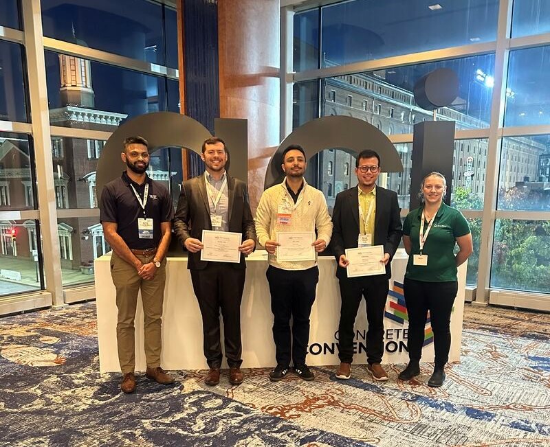 CEE graduate student Shayan Khan, center, pictured receiving his first place award at the ACI Conference Student Research Competition.