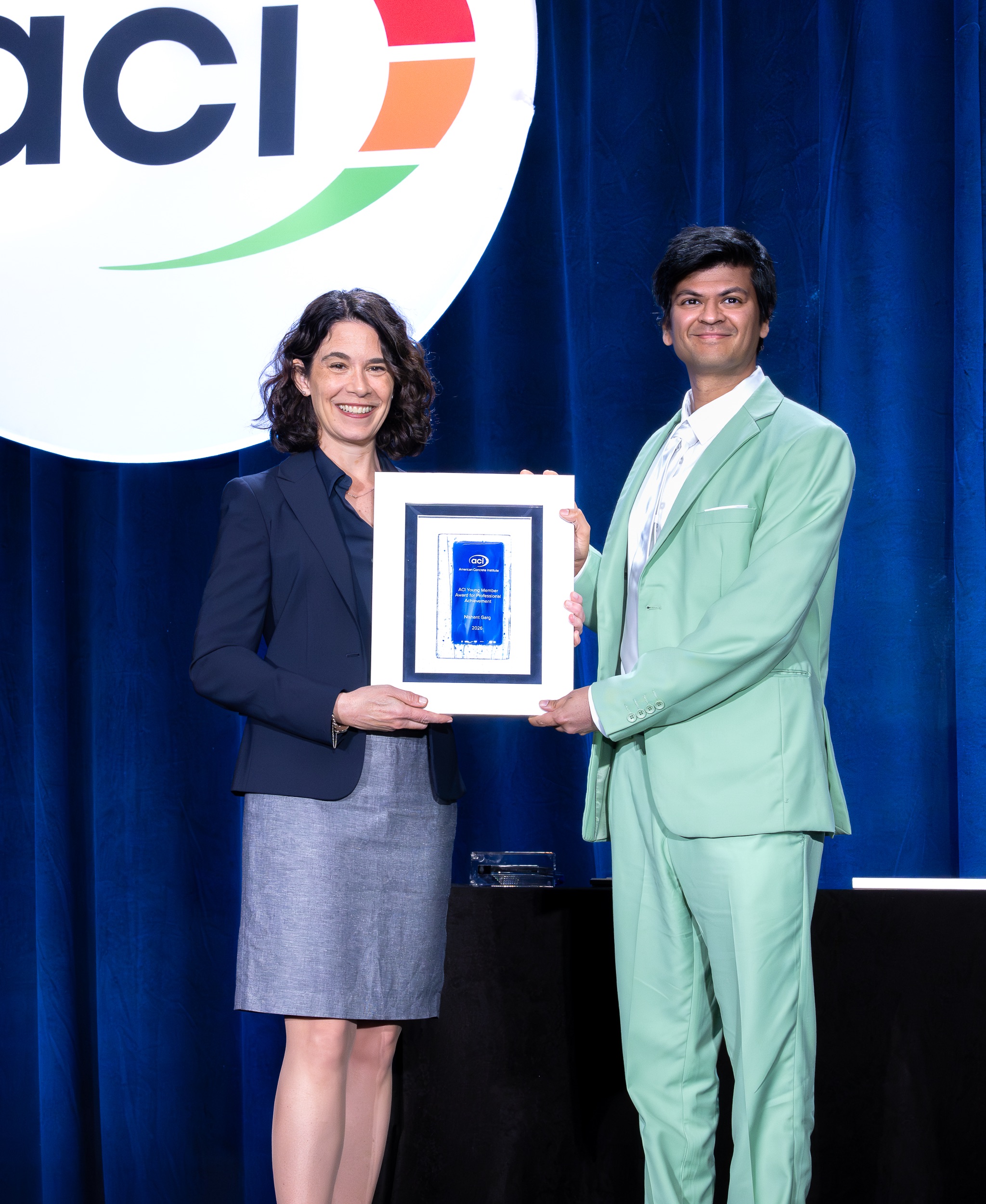 CEE Associate Professor Nishant Garg receives ACI Young Member Award for Professional Achievement from ACI President Maria Juenger at the 2026 Spring ACI Conference in Chicago, Ill.