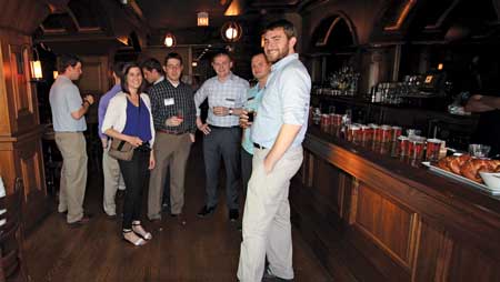 Young alumni gather at the bar during CEE's&nbsp;annual beer tasting at Revolution Brewing in Chicago.