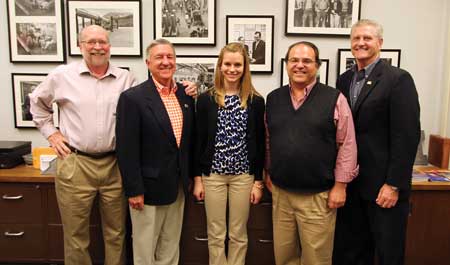 Group of alumni standing with scholarship awardee