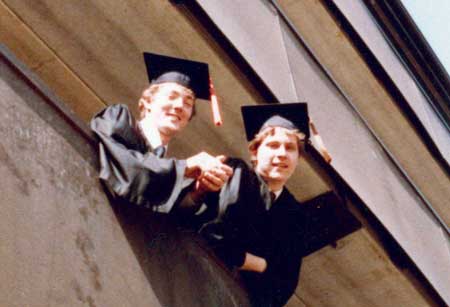 Photo of Ken Floody and a friend in graduation regalia.