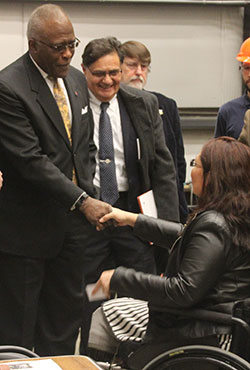 Chancellor Jones shakes hands with Senator Duckworth as professors Imad Al-Qadi and Christopher Barkan look on.