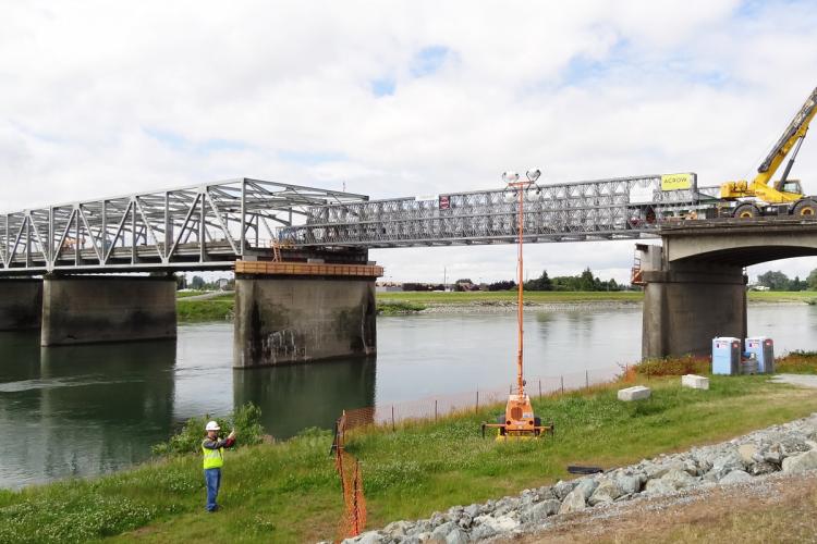 Crews work to replace the collapsed section of the I-5 bridge after the 2013 accident. Many bridges in Washington and other states have the same design, so understanding this collapse could help prevent others. Photo by Tim Stark