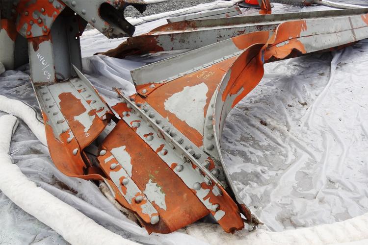 An oversized truck hit the second support frame of the bridge, twisting and deforming it like plastic and causing a chain reaction that collapsed the entire section of the bridge. Photo by Tim Stark