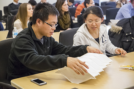Workshop attendees examine a design by Tachi.