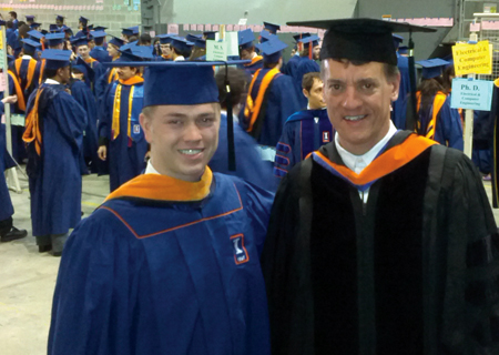Professor Bill Buttlar, right, poses with Sean McIlwee, the first student to graduate with a master's degree earned entirely online from CEE Online.