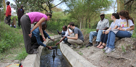 students take a water sample