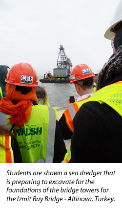 students view a sea dredger