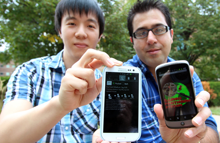 hyungchul yoon and reza shiftehfar display screen shots from the smart phone apps they developed to help emergency personnel in rescuing people trapped in buildings after disasters.