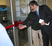 Professor David Lange cuts the ribbon to the new airport safety offices in Newmark Lab.