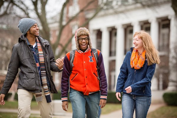 Group of students laughing, wearing Illinois apparel