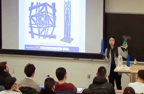 Zhang demonstrating models of optimized structures from research in the class.