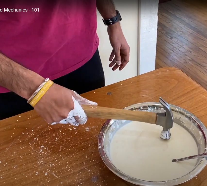 A student demonstrates the concept of fluid mechanics in the exhibit, DIY Fluid Mechanics - 101