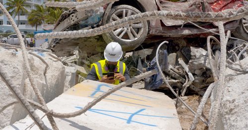 In this July 2, 2021, photo, a NIST staff member tags and photographs a building element that has been identified for preservation as evidence in the staging area near the site of the Champlain Towers South building collapse. Credit: NIST