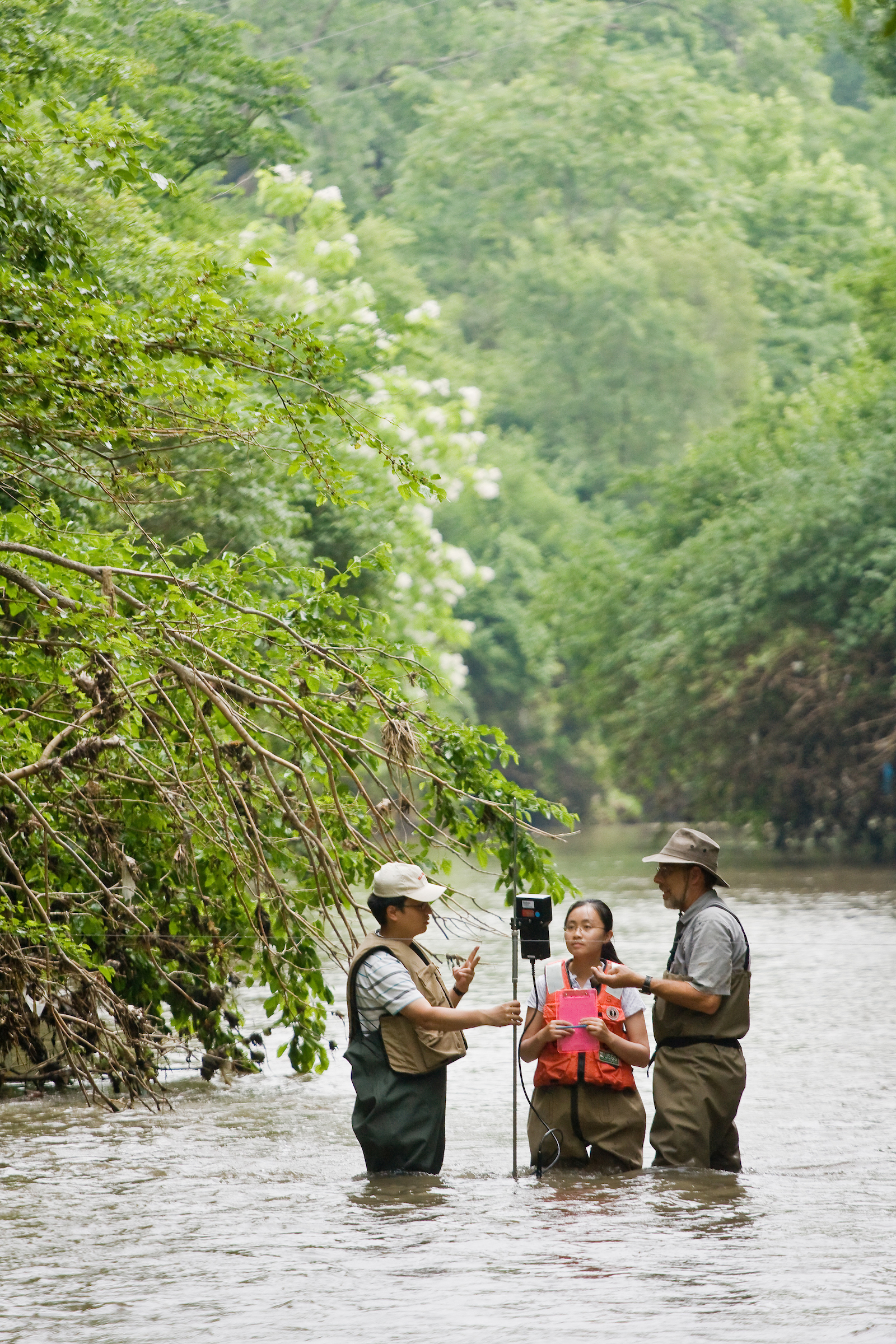 students and professor taking measurements in the field