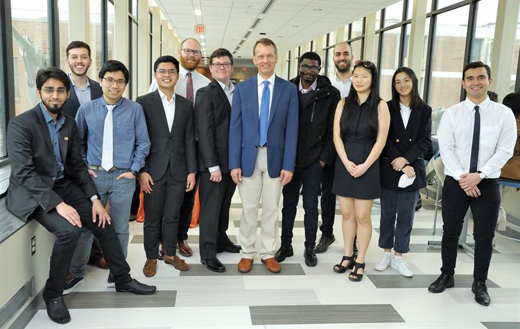 The CEE 573 class gathers on the bridge during the Grand Opening. Left to right: Shaik Althaf V. Shajihan, Brian Welsh, Huy Tran, Ray Ausan, Travis Fillmore, Alex Fields, Professor Bill Spencer, Thomas Ngare Matiki, Mohammad Fakhreddine, Casey Rodgers, Mandy Zhong, Ricardo Dorado. Not pictured, Laurelin Strom (who took the class remotely).