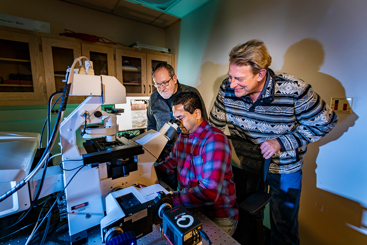 In studies combining geology, biology, engineering and history, U. of I. researchers Marcelo Garcia, left, Mayandi Sivaguru, seated, and Bruce Fouke are the first to document geologic ripple marks formed by mineral growth and use them to reconstruct the hydraulic history of the Roman aqueducts. Photo by Fred Zwicky