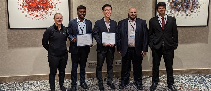 Sangmin Lee, center, won first place in the student research presentation competition. Second from left is Kirshna Polavaram, third place winner. Also pictured are the award sponsor representative and session chairs, including CEE assistant professor Nishant Garg at far right.
