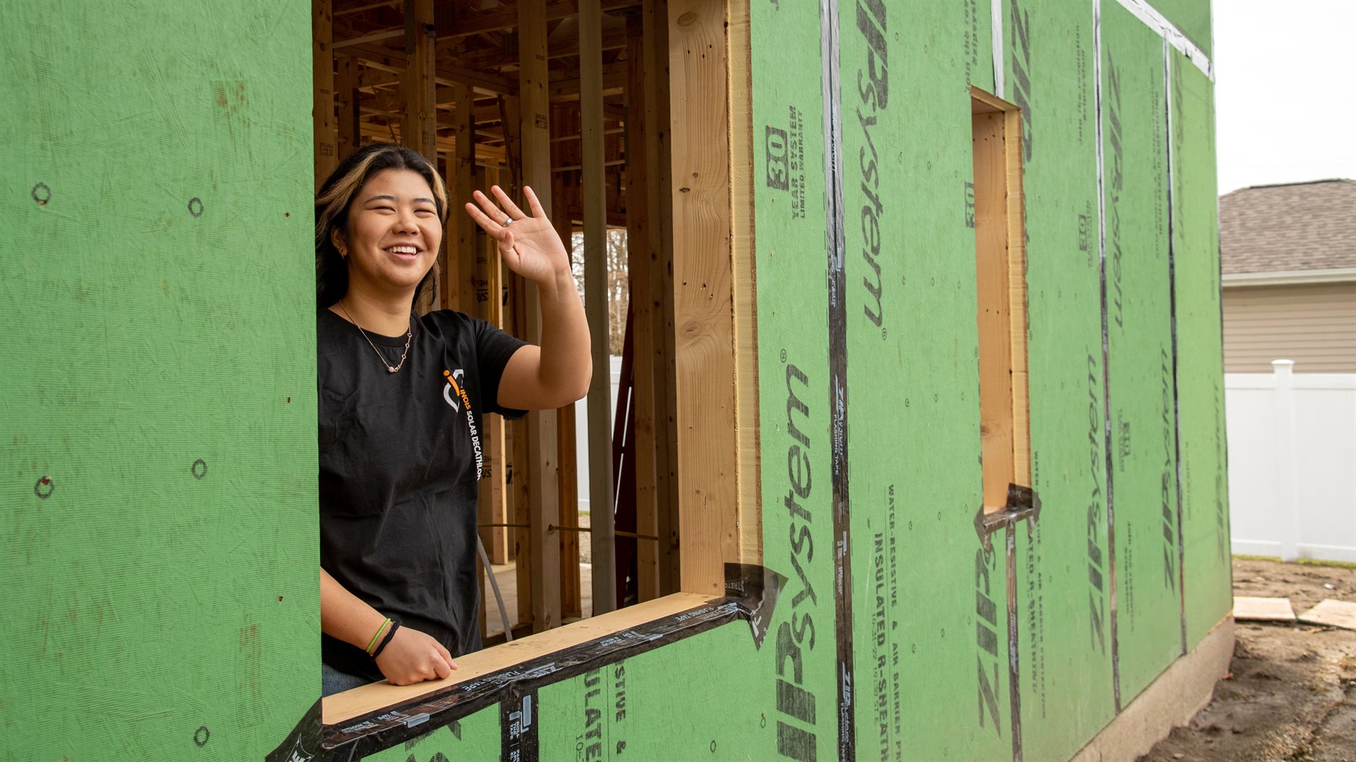 Julie Wang, a Global Studies major in the College of Liberal Arts and Sciences and&amp;amp;amp;amp;amp;amp;nbsp;who serves as ISD's Communications Director, waves from a window during a visit to the construction site.