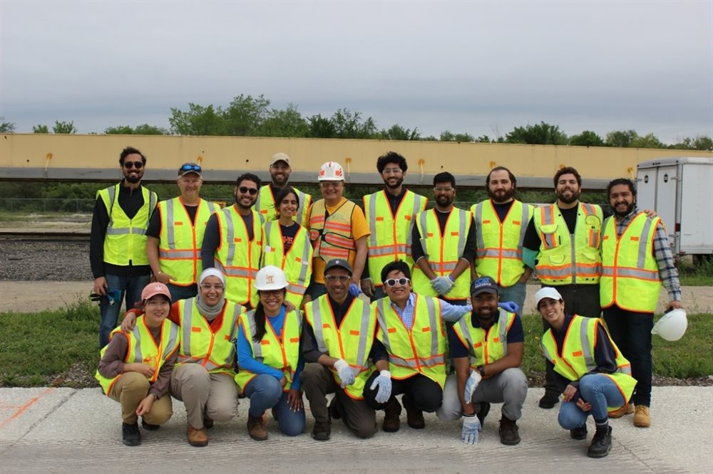 Illinois Center for Transportation graduate students and staff smile with R27-216 project leads Imad Al-Qadi (top row, fifth from left) and CEE graduate research assistant Javier Garc&amp;amp;amp;iacute;a Mainieri (top row, second from right) after construction and instrumentation of the test area at ICT on May 15.